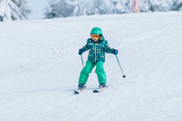 Little boy skiing down the hill